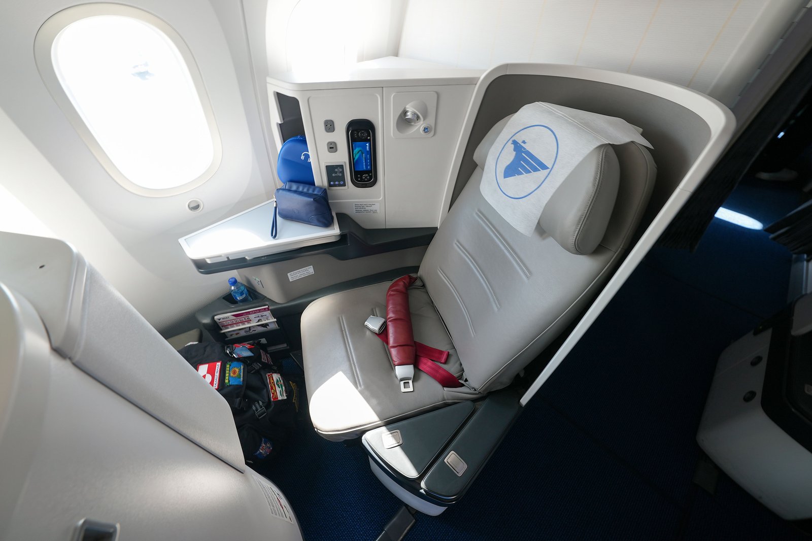 An empty business-class pod by a window