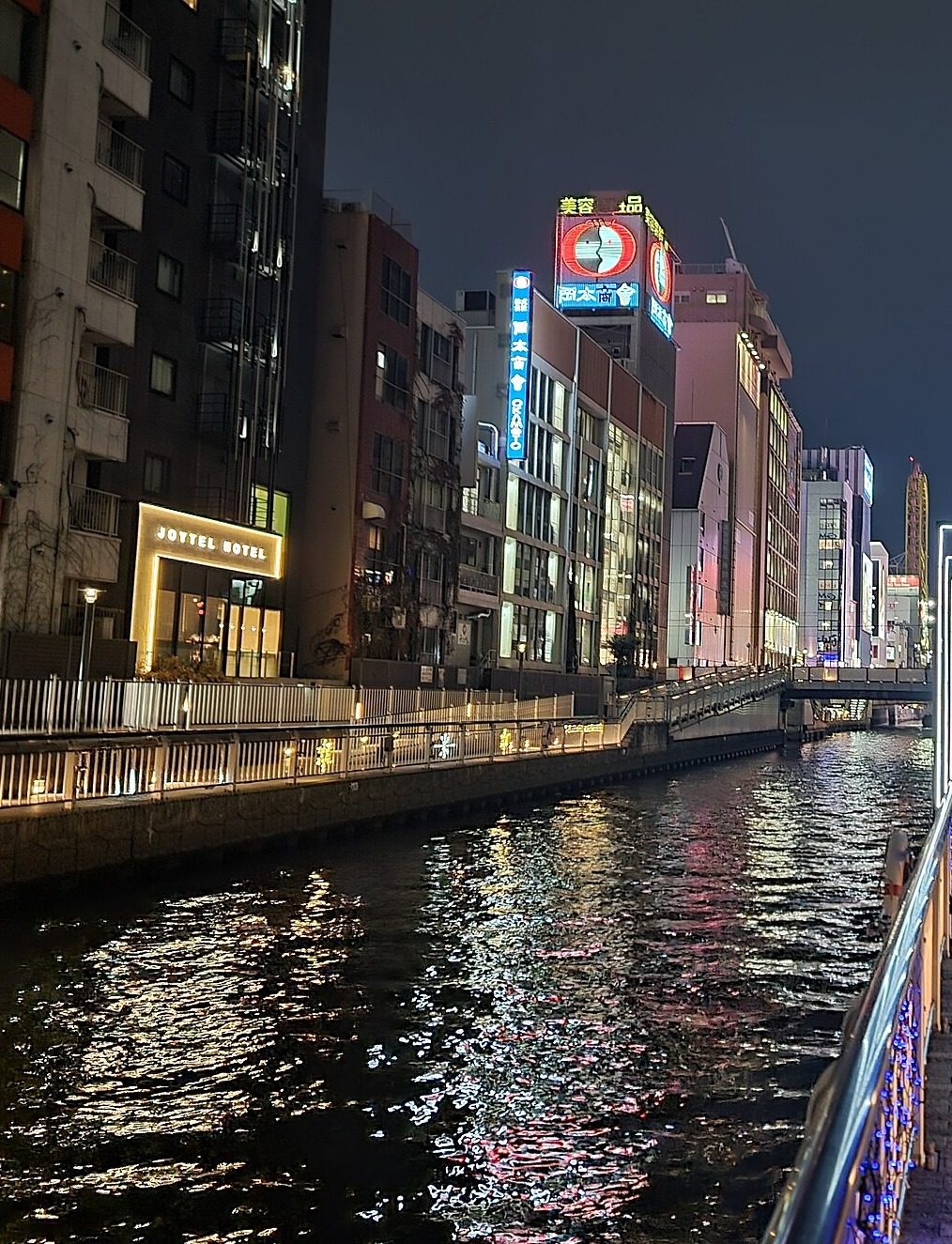 Dotonbori canal at night with neon reflections on the water